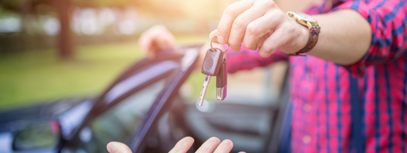 Man handing car keys over
